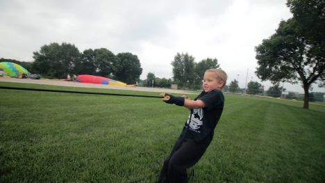 small child as part of hot air balloon racing crew