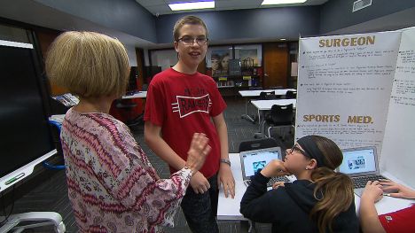 Matthew interacts with his teacher at school.