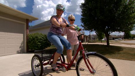 Lainie rides a bicycle.