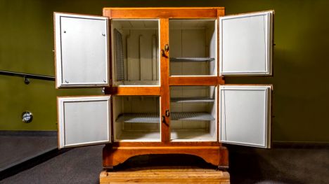 Wooden cabinet with four doors with insulated compartments inside.