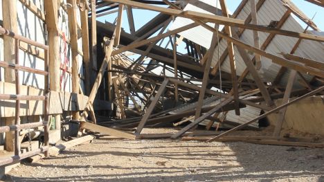 A farm building is destroyed by a tornado.