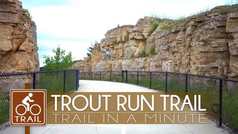 A paved path winds through small bluffs.