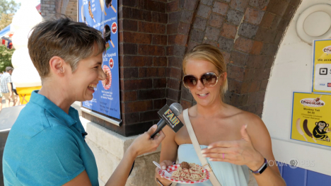 Charity interviewing someone eating a new Fair food