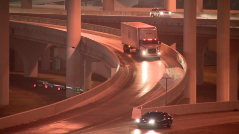 A semi and other vehicles on slick overpasses.