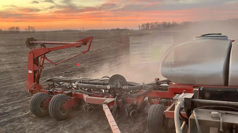 A crop planter rolls down the field.