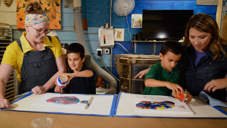 two kids creating art alongside two adults