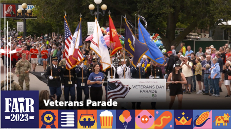 Veterans Parade - group of individuals holding military, USA and State of Iowa flags