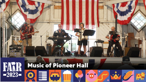 Music of Pioneer Hall- 4 member band standing on a stage