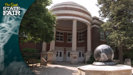 Two-story brick structure with a four columns holding up a rounded dome over the entrance