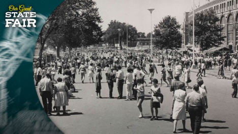 Crowds walk along Grand Avenue in front of the Grandstand