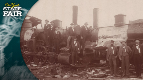 A group of men stand around to train locomotives