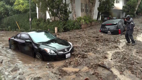 Two cars stuck in mud.