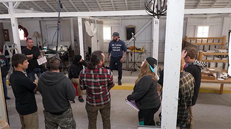 A film crew gathers around a scene/set at Mediaverse Studios.
