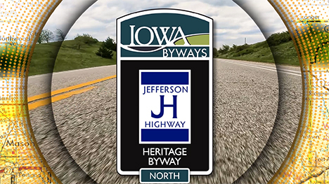 Iowa Byways: Jefferson Highway Heritage Byway sign overlayed on a road background.