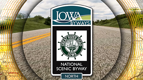 Iowa Byways: Great River Road National Scenic Byway sign overlayed on a road background.