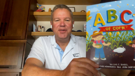 Tony Thelen shows ABC's of Corn book.