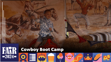 Cowboy Boot Camp - kid sitting on a barrel and swinging a lasso at a pretend bull