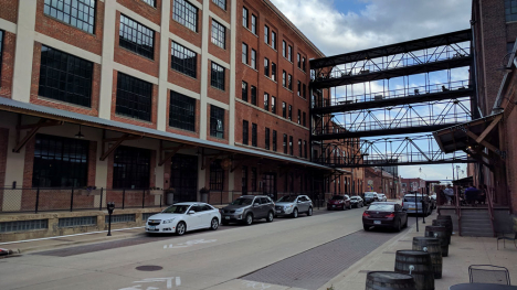A five-story red brick building fills an entire city block