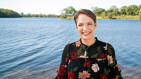 Host, Charity Nebbe stands along a lakeshore.
