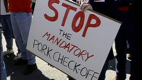 A sign that reads, "STOP THE MANDATORY PORK CHECK-OFF."