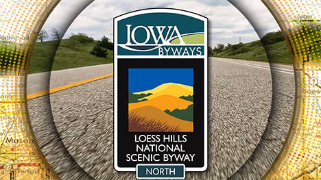 Loess Hills National Scenic Byway North sign overlayed on a road background.