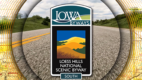 Loess Hills National Scenic Byway South sign overlayed on a road background.