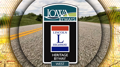 Iowa Byways: Lincoln Highway Heritage Byway West sign overlayed on a road background.
