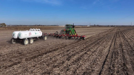 Tractor applying nitrogen to soybean field