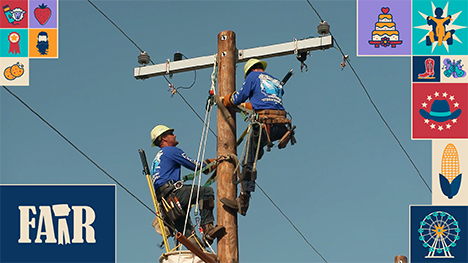 Two powerline electrician technicians participate in the Lineman’s Rodeo atop a powerline pole.