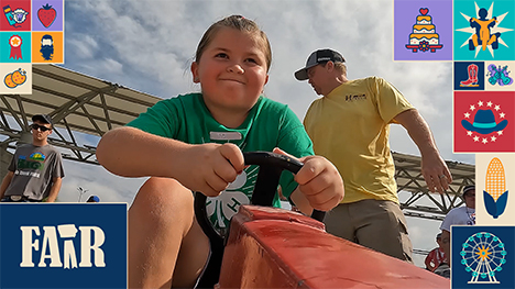 A girl pedals a toy tractor in the Pedal Tractor Pulls at the Iowa State Fair.