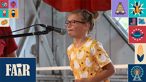A girl in a chicken patterned shirt competes at the microphone in the Youth Rooster Crowing contest.
