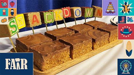 A festive display of eight scotcharoo bars on a wooden plank with children's letter blocks spelling the word "SNACKDOWN" behind the bars.