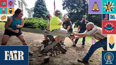 Onlookers watch a man and woman saw a piece of wood in the timber sports showdown at the Iowa State Fair.