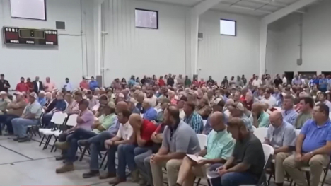 farmers seated in high school gym
