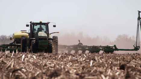 tractor pulling planter through a field
