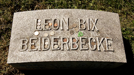 Bix Beiderbecke Tour | A gravestone sprinkled with coins that has the name, "LEON BIX BEIDERBECKE."