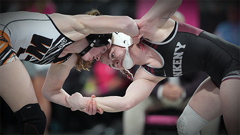 Two high school female wrestlers compete head to head.
