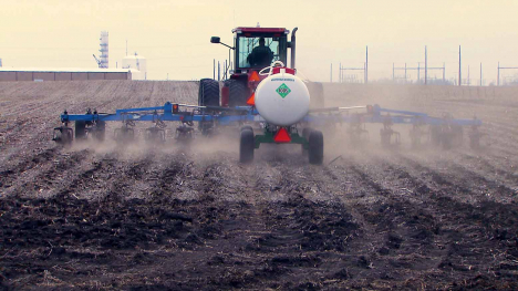 tractor pulling an implement to apply anhydrous ammonia fertilizer