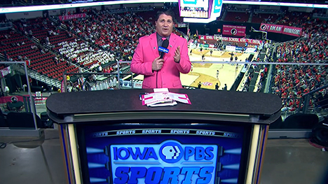 Host, Paul Yeager at the Iowa PBS Sports desk overlooking the Casey's Center arena basketball court.