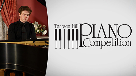 A boy in a black shirt and tie plays a grand piano. The Terrace Hill Piano Competition logo.
