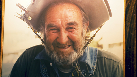 A photo of a bearded hobo in a hat at the National Hobo Museum.