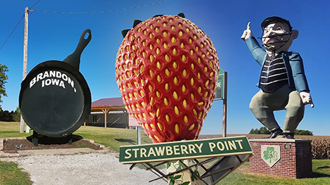 three larger-than-life roadside attractions: a giant frying pan, a giant strawberry and a giant statue of a baseball umpire.