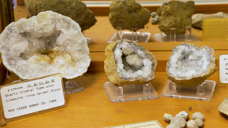 A display of geodes in front of a mirror.