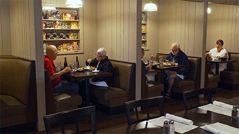Several patrons sit and eat in semi-private booths at Archie's Waeside.