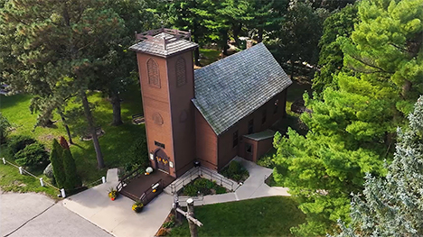 An aerial view of the Little Brown Church in the Vale surrounded by trees.