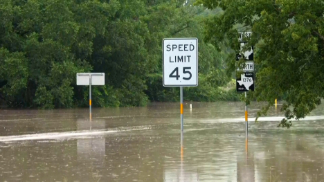 Street signs in Texas Hill Country flood waters.