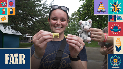 A woman holds up two tiny "butter cows" while a man holds up a stuffed animal over her left shoulder.